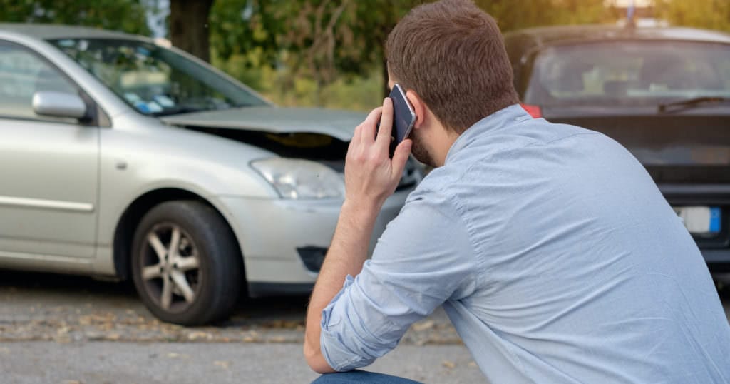 Frustrated person after car accident talking to insurance company