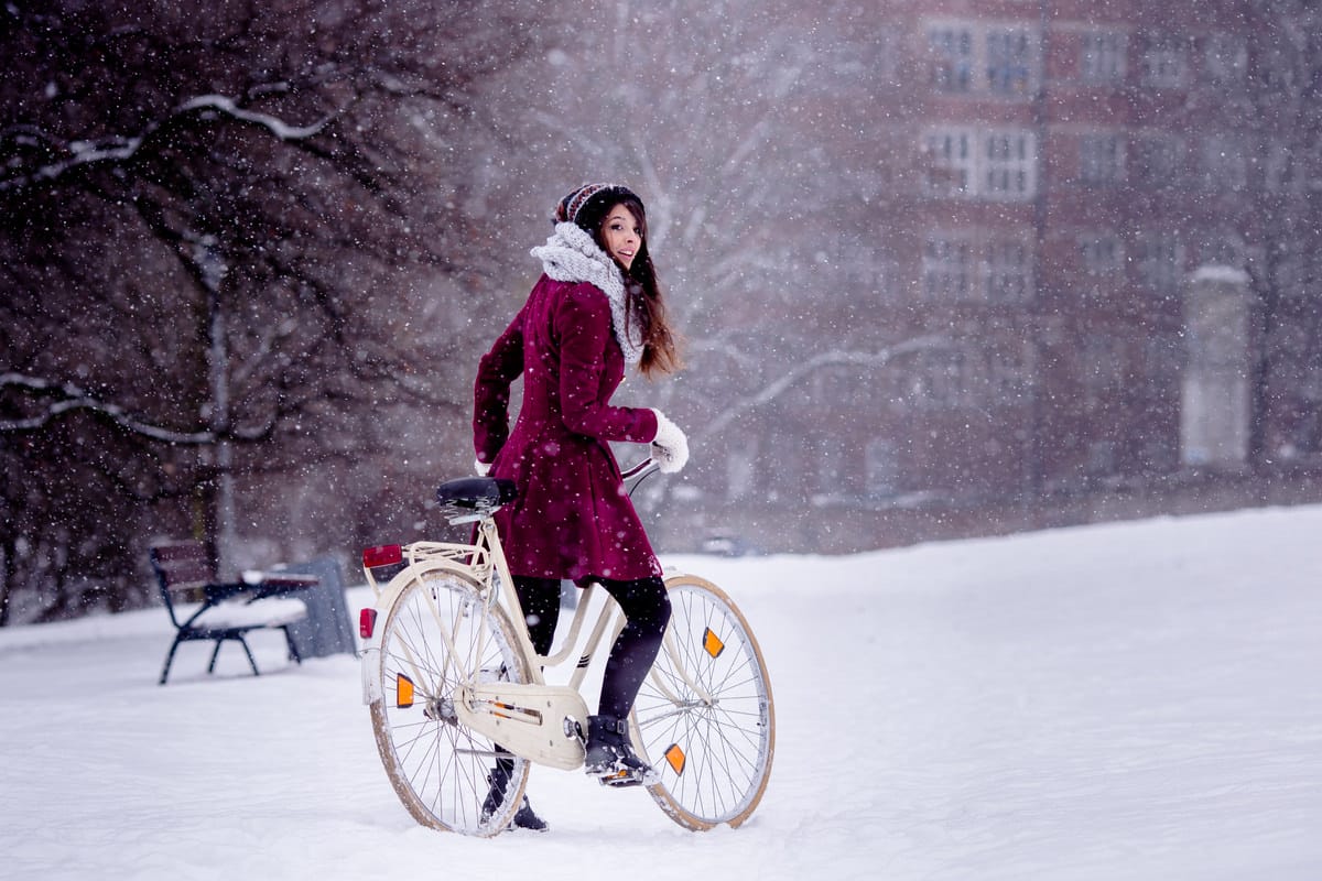 image of woman biking in snow denver accident lawyer